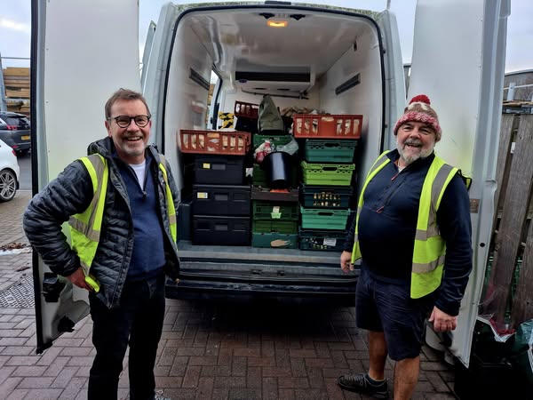 Foodhub volunteers loading van with seasonal surplus food